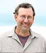 Headshot of author John Stansifer with beach background