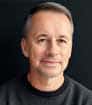 Head shot photo of author David Brown wearing charcoal T-shirt